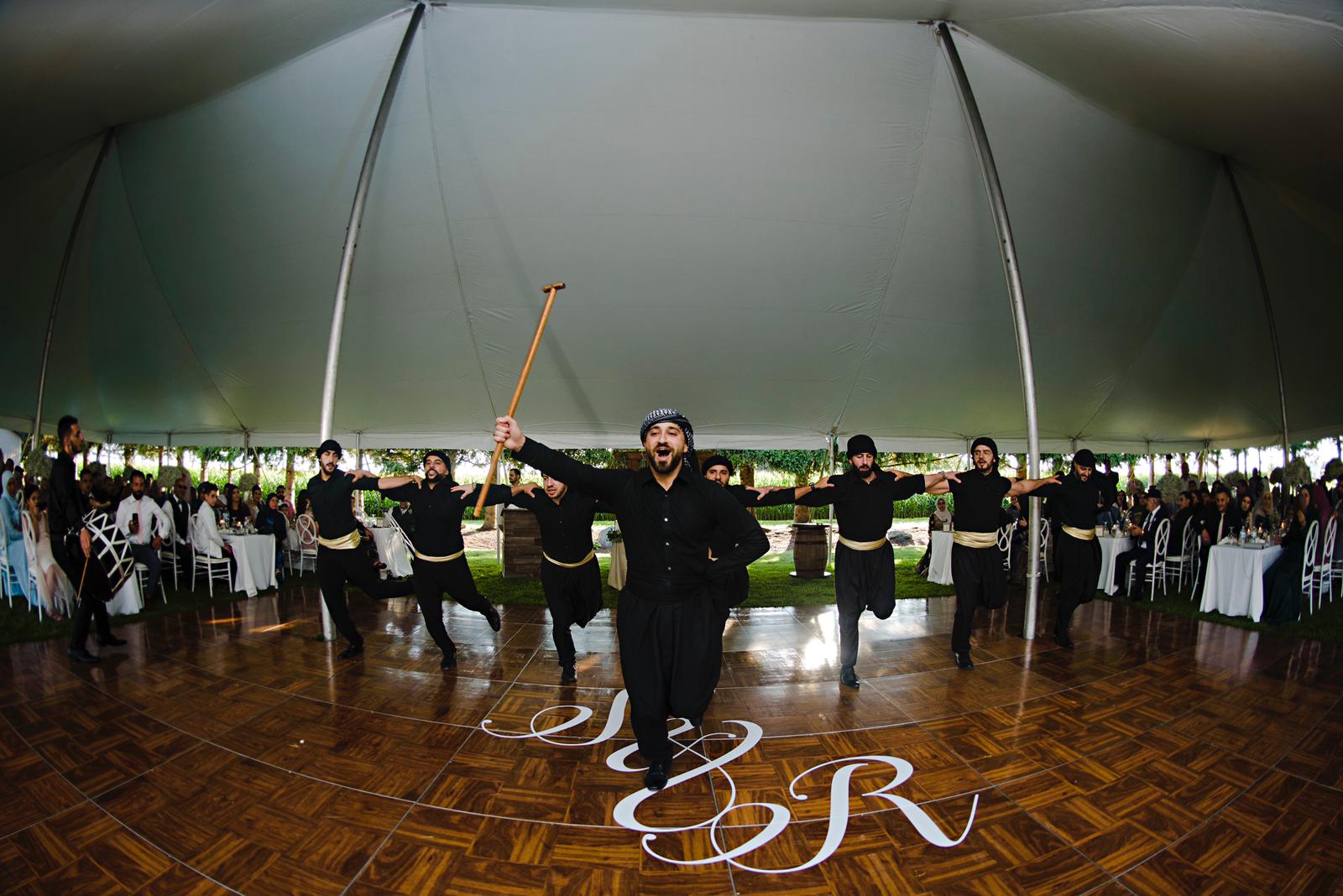 Abu Idris leading a dabke line at a wedding reception
